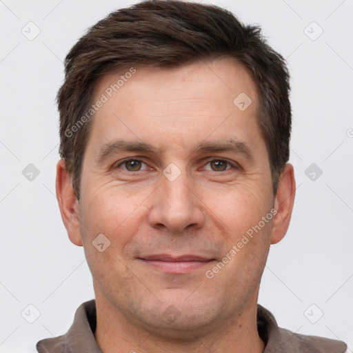 Joyful white adult male with short  brown hair and brown eyes