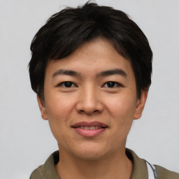 Joyful asian young-adult male with short  black hair and brown eyes