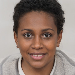 Joyful black young-adult female with short  brown hair and brown eyes