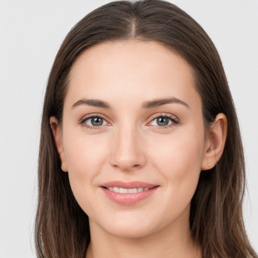 Joyful white young-adult female with long  brown hair and grey eyes