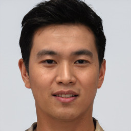 Joyful asian young-adult male with short  black hair and brown eyes