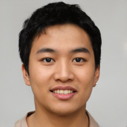 Joyful asian young-adult male with short  black hair and brown eyes