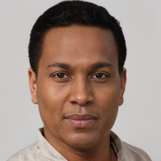 Joyful black young-adult male with short  brown hair and brown eyes