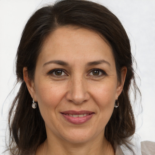 Joyful white adult female with medium  brown hair and brown eyes