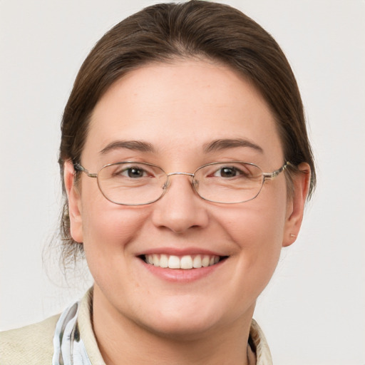 Joyful white adult female with medium  brown hair and grey eyes