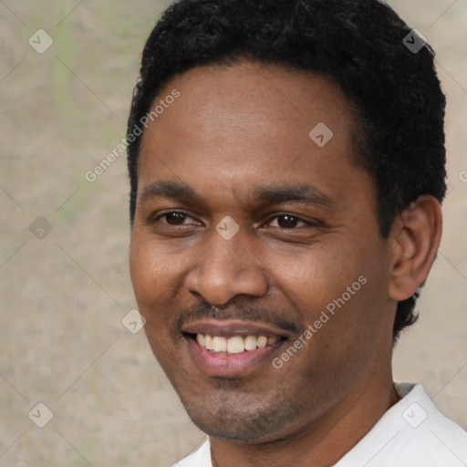 Joyful black adult male with short  black hair and brown eyes