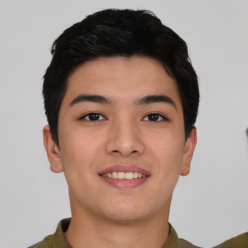 Joyful asian young-adult male with short  brown hair and brown eyes