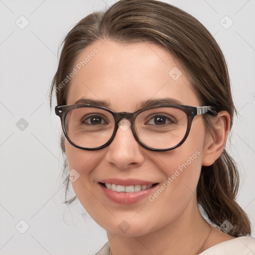 Joyful white young-adult female with medium  brown hair and blue eyes