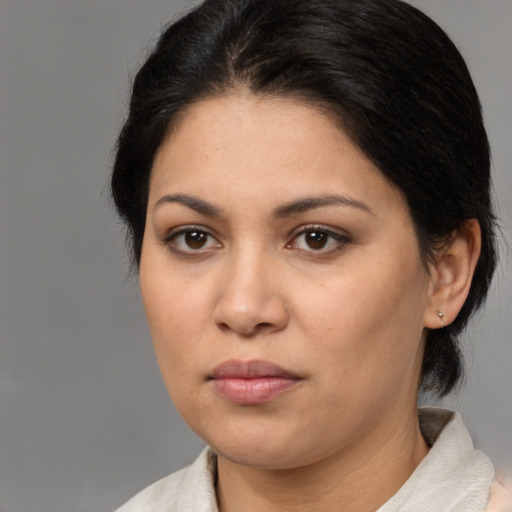 Joyful latino young-adult female with medium  brown hair and brown eyes