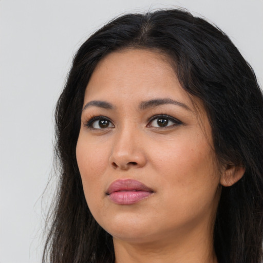 Neutral latino young-adult female with long  brown hair and brown eyes
