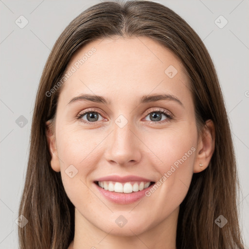 Joyful white young-adult female with long  brown hair and grey eyes