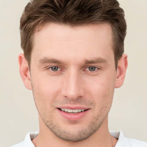 Joyful white young-adult male with short  brown hair and brown eyes