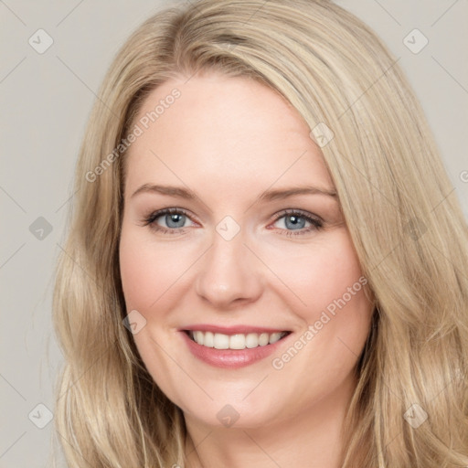 Joyful white young-adult female with long  brown hair and blue eyes