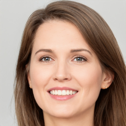 Joyful white young-adult female with long  brown hair and brown eyes