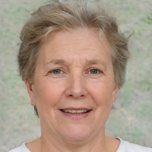 Joyful white middle-aged female with short  brown hair and grey eyes