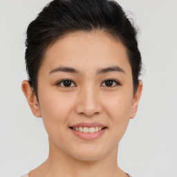 Joyful asian young-adult female with short  brown hair and brown eyes