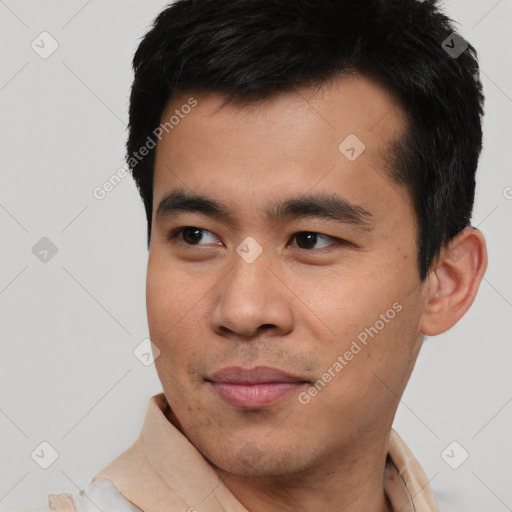 Joyful asian young-adult male with short  black hair and brown eyes