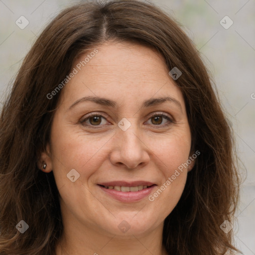 Joyful white adult female with long  brown hair and brown eyes