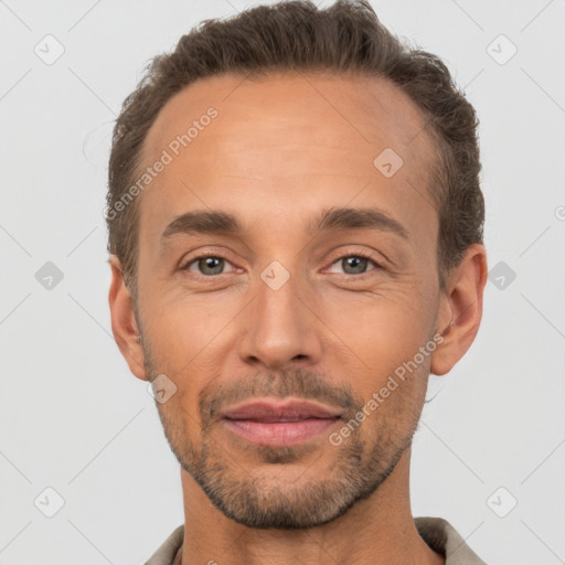 Joyful white adult male with short  brown hair and brown eyes