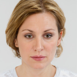 Joyful white young-adult female with medium  brown hair and green eyes