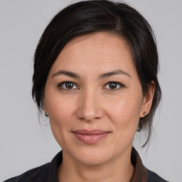 Joyful white adult female with medium  brown hair and brown eyes