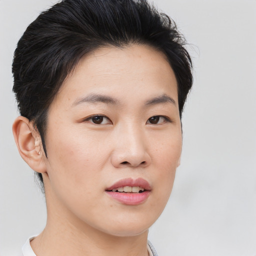 Joyful asian young-adult female with short  brown hair and brown eyes