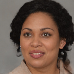 Joyful black adult female with medium  brown hair and brown eyes