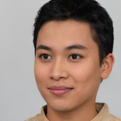 Joyful asian young-adult male with short  brown hair and brown eyes