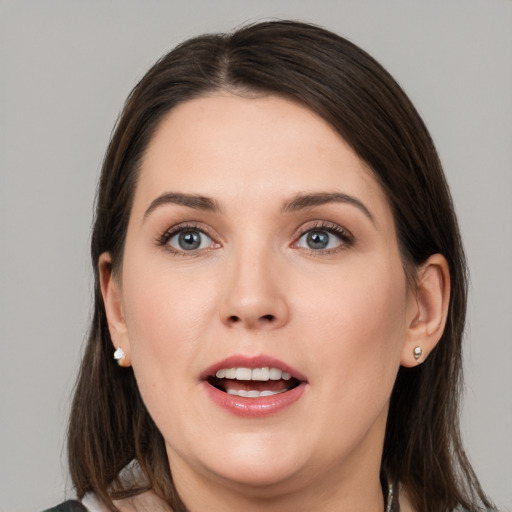 Joyful white young-adult female with medium  brown hair and grey eyes