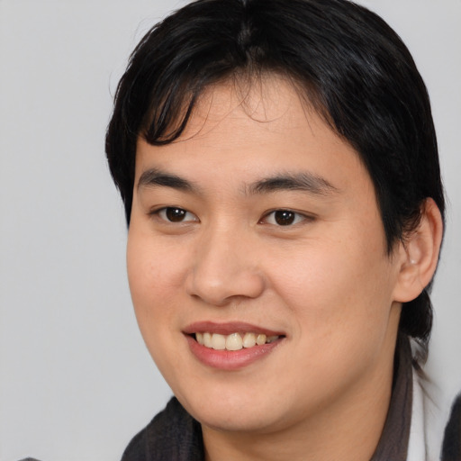 Joyful asian young-adult female with medium  brown hair and brown eyes