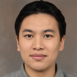 Joyful asian young-adult male with short  black hair and brown eyes