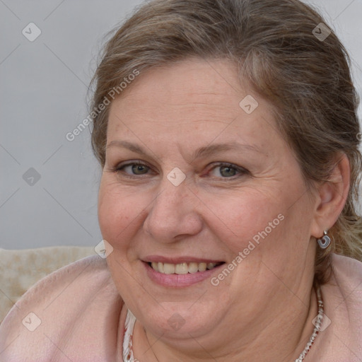 Joyful white adult female with medium  brown hair and blue eyes