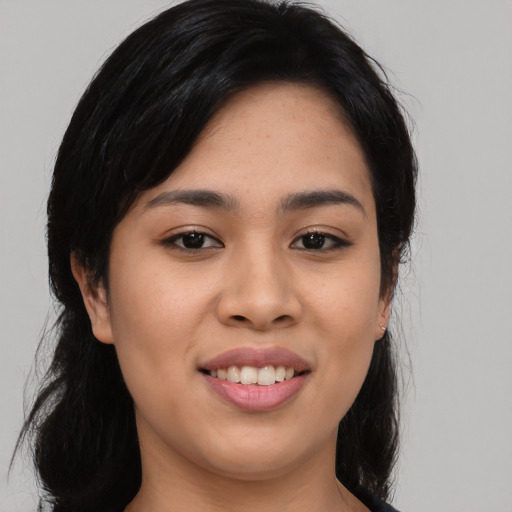 Joyful asian young-adult female with long  black hair and brown eyes