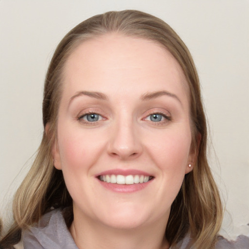 Joyful white young-adult female with medium  brown hair and blue eyes