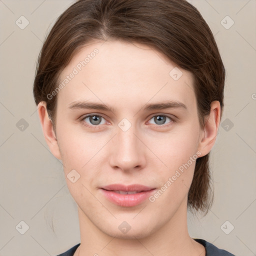 Joyful white young-adult female with medium  brown hair and grey eyes