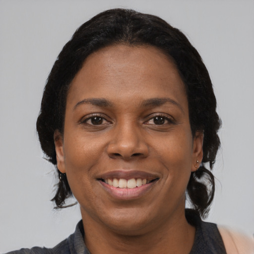 Joyful black young-adult female with medium  black hair and brown eyes