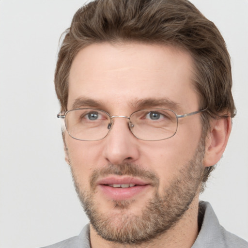 Joyful white adult male with short  brown hair and grey eyes