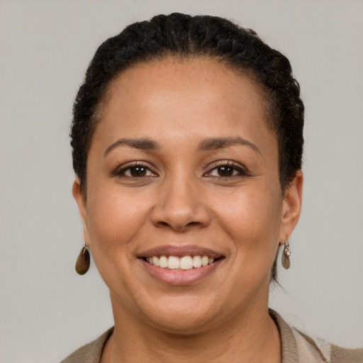 Joyful latino young-adult female with short  brown hair and brown eyes