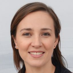 Joyful white young-adult female with medium  brown hair and brown eyes