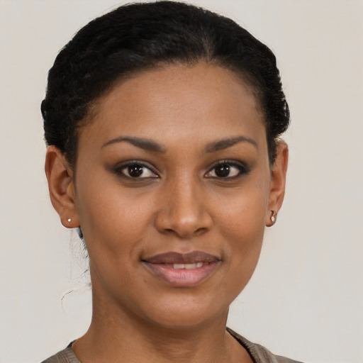 Joyful black young-adult female with short  brown hair and brown eyes