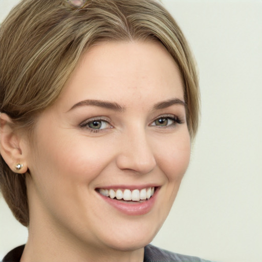 Joyful white young-adult female with medium  brown hair and grey eyes