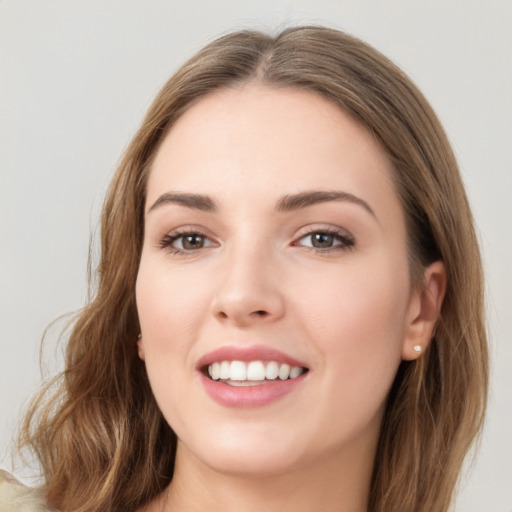 Joyful white young-adult female with long  brown hair and green eyes