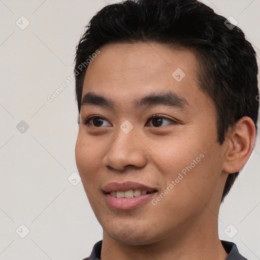 Joyful asian young-adult male with short  black hair and brown eyes