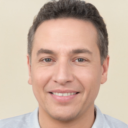 Joyful white adult male with short  brown hair and brown eyes