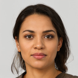 Joyful latino young-adult female with medium  brown hair and brown eyes