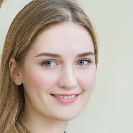 Joyful white young-adult female with long  brown hair and blue eyes