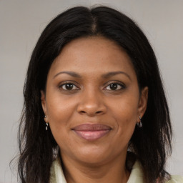 Joyful black adult female with medium  brown hair and brown eyes