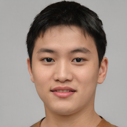 Joyful asian young-adult male with short  black hair and brown eyes