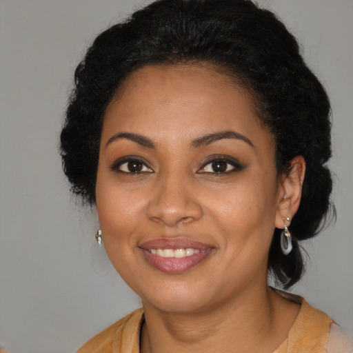 Joyful black young-adult female with medium  brown hair and brown eyes