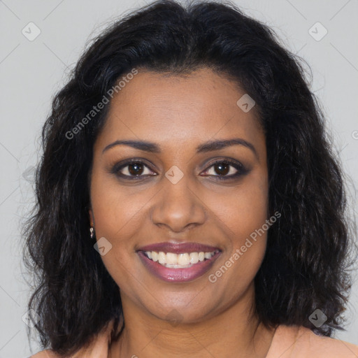Joyful black young-adult female with long  brown hair and brown eyes